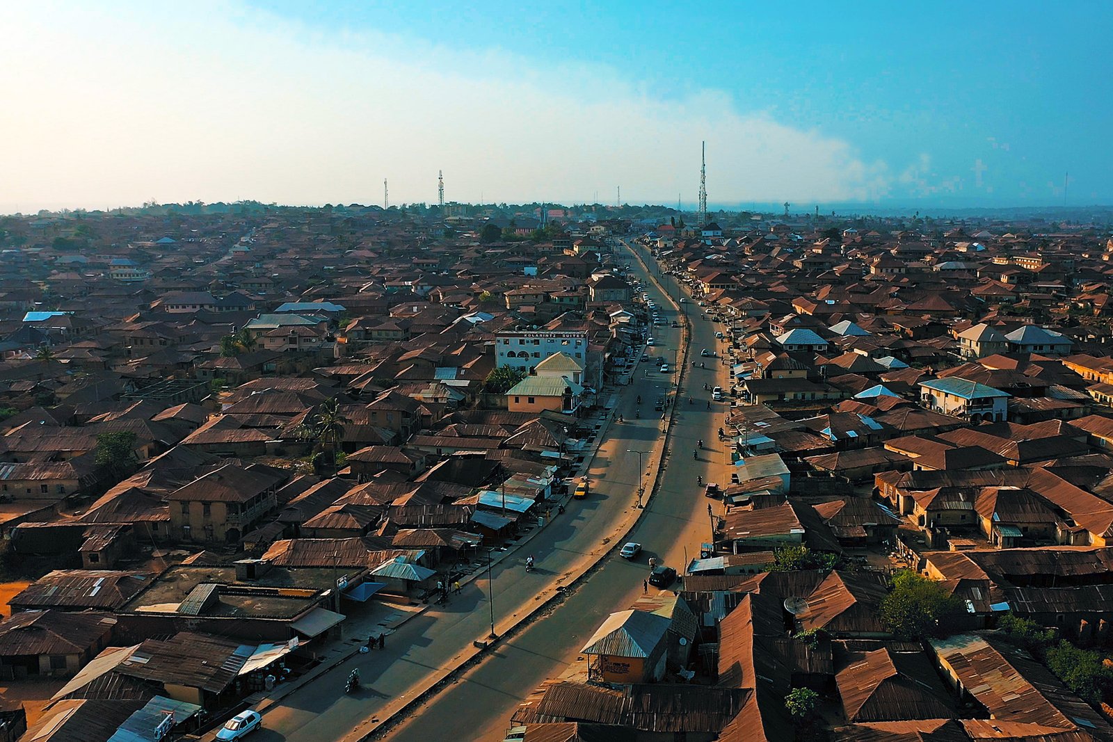 Aerial view of Ogbomoso, with a main road running through dense low-rise neighborhoods.